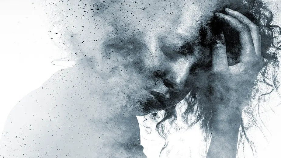 woman in a dusty cloud holding her head with one hand