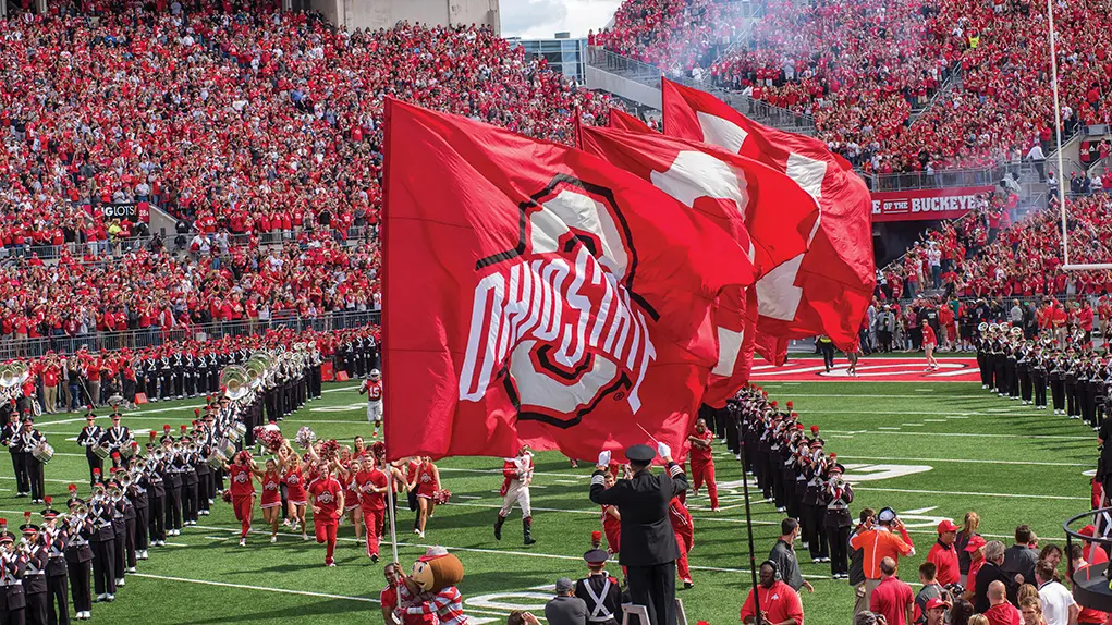 Cheerleaders fly giant flags at Ohio Stadium