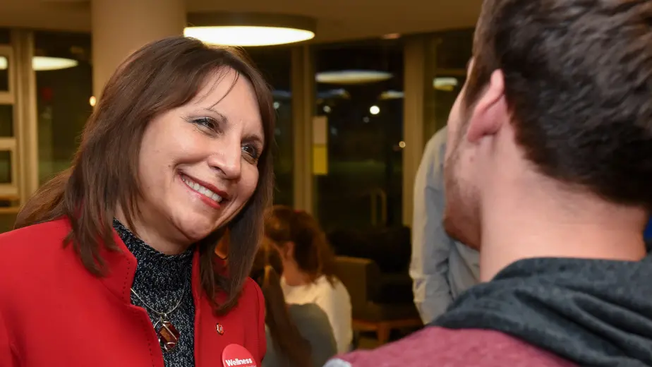 Bernadette Mazurek Melnyk is speaking to a young man.