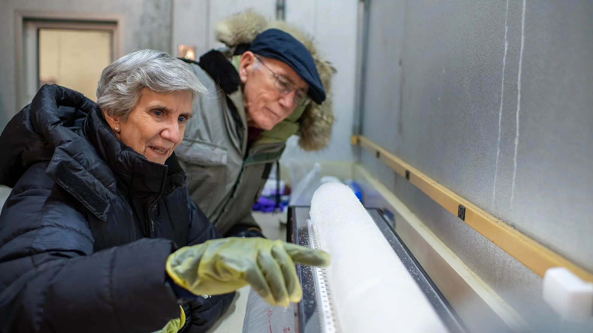 Ellen Mosley-Thompson and Lonnie Thompson examining ice core.