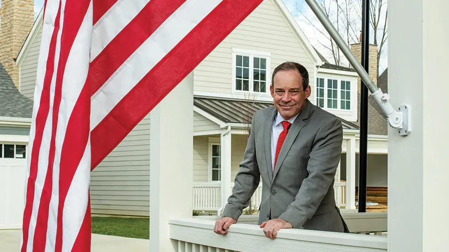 Air Force Col. Kevin Cullen standing by american flag