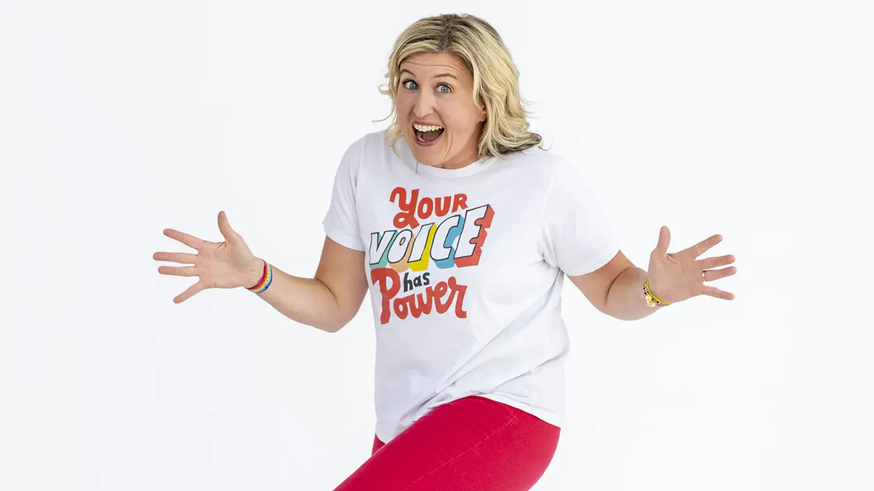 Katie Silcott dances in t-shirt that reads "Your voice has power."