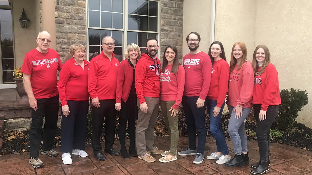 Ten family members of three generations, all wearing Ohio State scarlet shirts, stand in a single line.