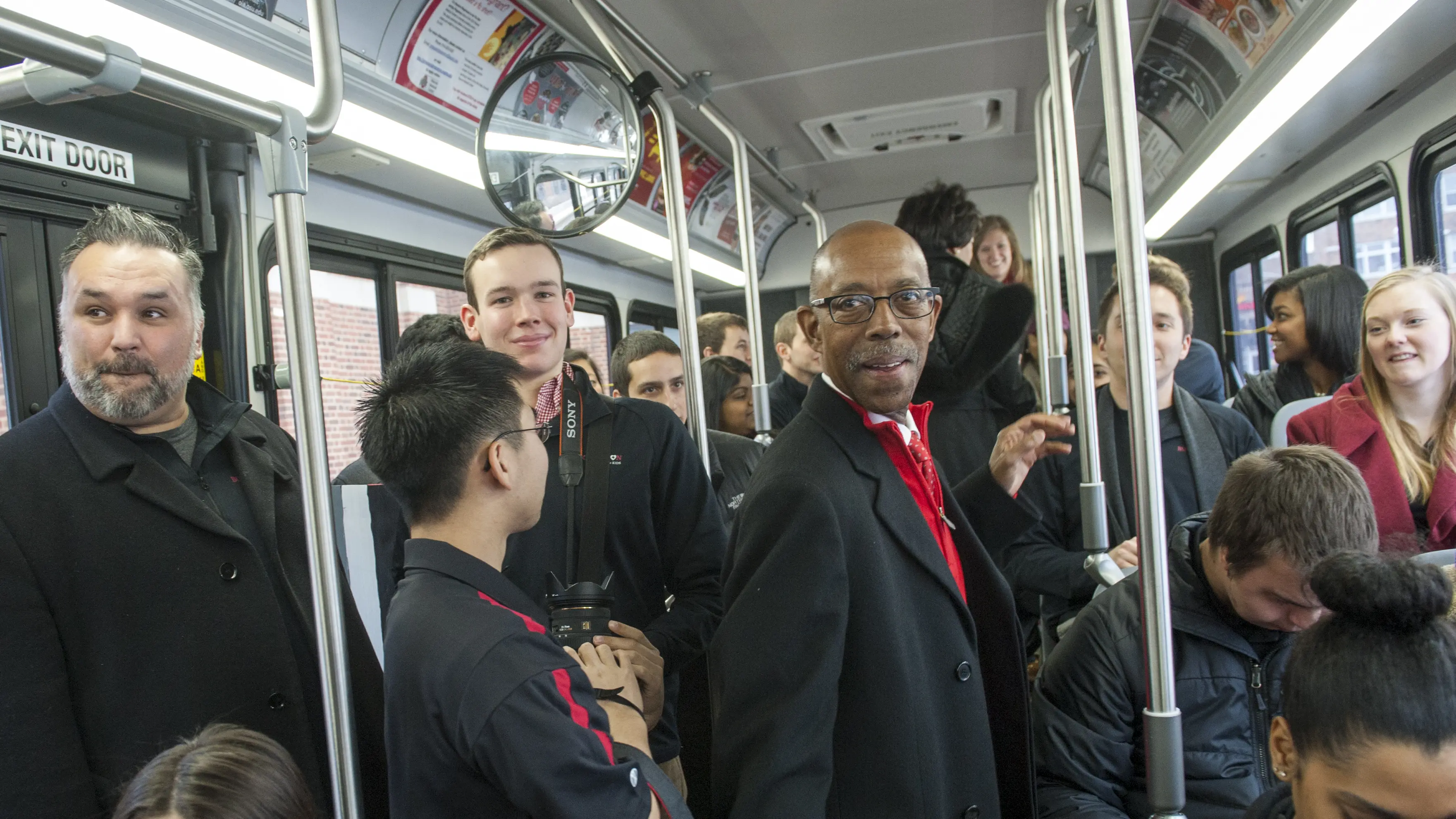 President Drake standing on a crowded bus