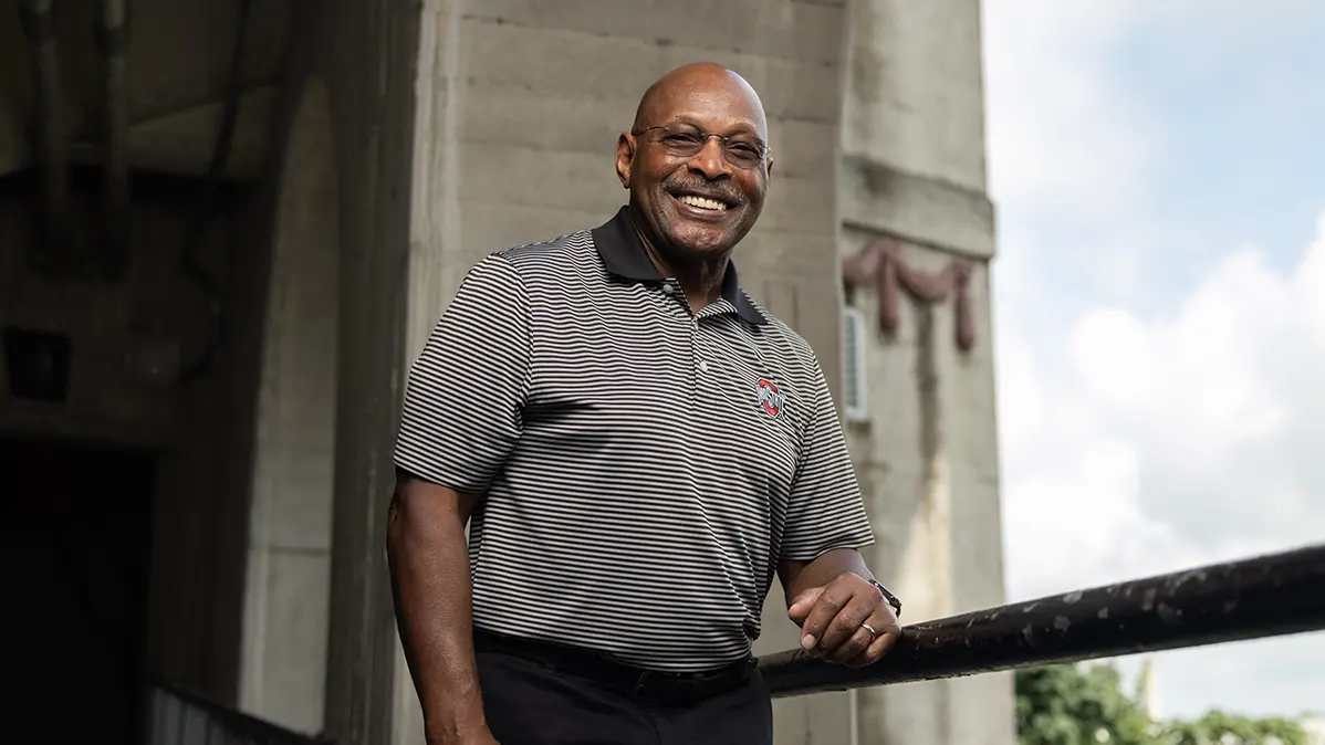 Ohio Stadium’s iconic concrete arches are the background for Ohio State’s iconic Archie Griffin, who grins as he poses for the photo.