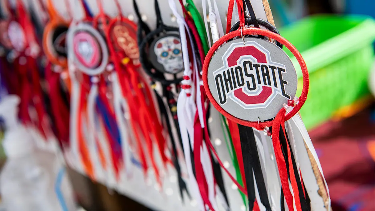 An Ohio State ornament hangs at the front of a colorful display. Many others have round displays that show sugar skulls.