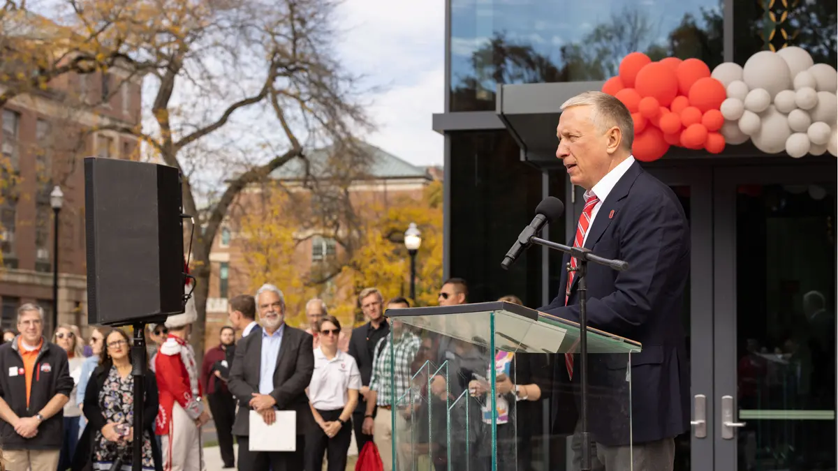 In a photo captured of a rare moment — Ratmir Timashev not smiling but looking sober — he speaks at a podium at the dedication of Ohio State’s new music building. Balloons and a crowd can be seen in the background.