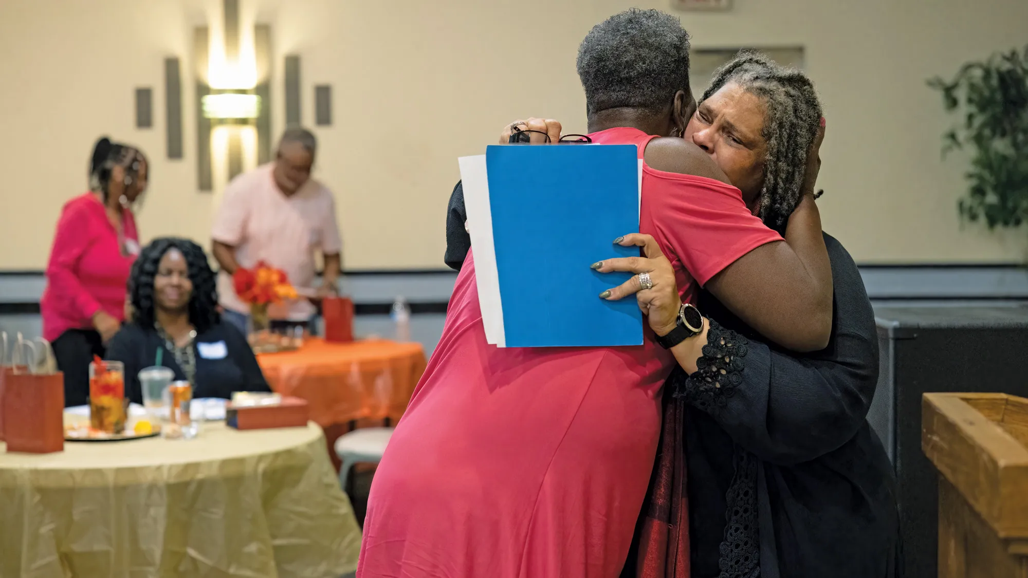 Palmer gets a comforting hug from a woman who listened to her speech. That woman can only be seen from the back, and Patrice’s expression suggests she has given her all, and been through a lot of emotions, as she shared her personal story. 