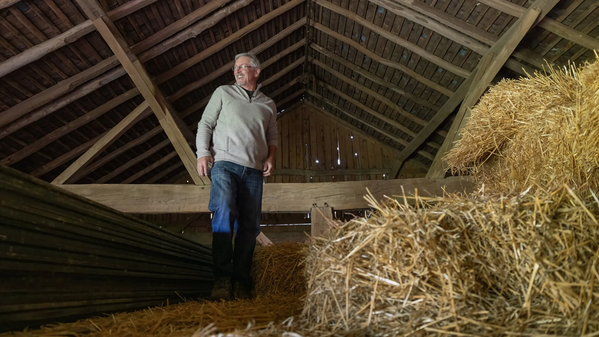 Doug Morgan surveys the loft inside an old barn he plans to dismantle, rebuild and refurbish, giving the old timber a new take on life.