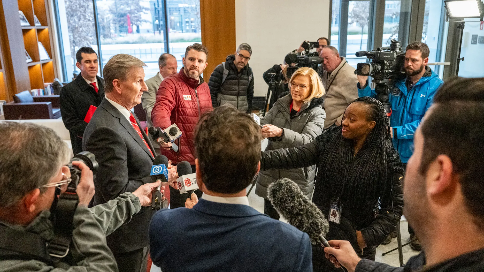 President Carter answers questions from local media reporters circled around him on the ground floor of the building his office is in. 