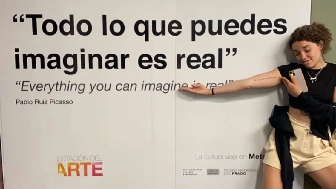 An Ohio State college student studying abroad in Madrid shows the subway station sign that inspired the tattoo she got to commemorate her experience. “Todo lo que puedes imaginar es real,” the sign says. 