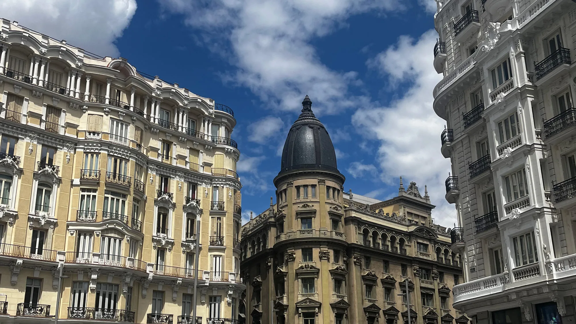 In downtown Madrid, where the streets Gran Via and Calle de Alcala cross, the tall, ornate buildings sport detailed window decor, railings and roof lines. They give off a uniquely European feel.