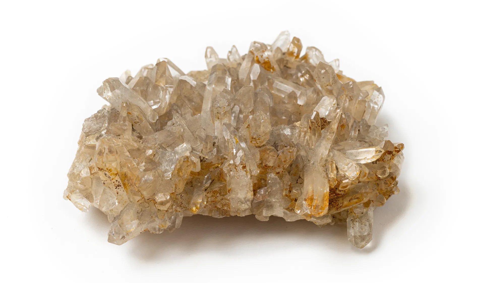 This palm-size clump of crystals is covered in small tetragonal, or “tower” shaped, prisms that grew in seemingly every possible direction. The color is a tan or off-white, though most of the structures are see-through. 