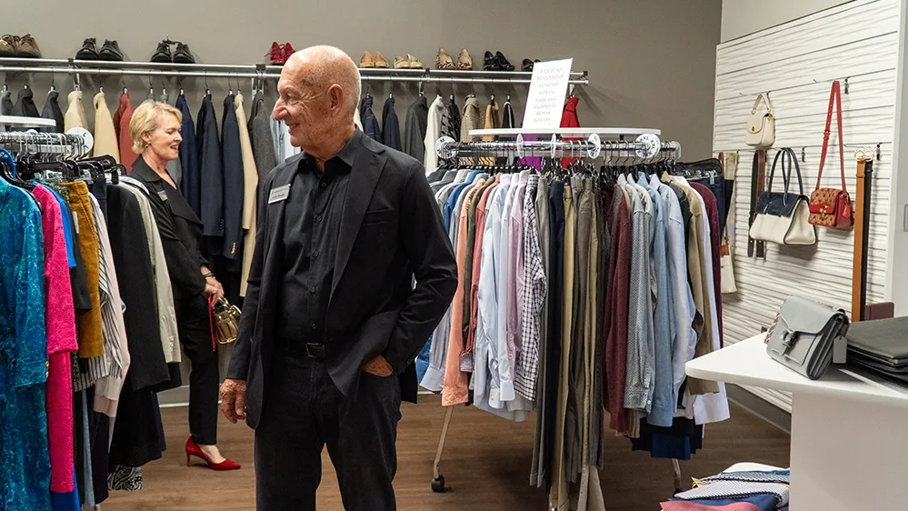 Veronica Brady and Keith Monda tour the clothing section of the just opened student resource center. Vernoica Brady looks particularly pleased as she seems to be exclaiming "wow" in this photo.