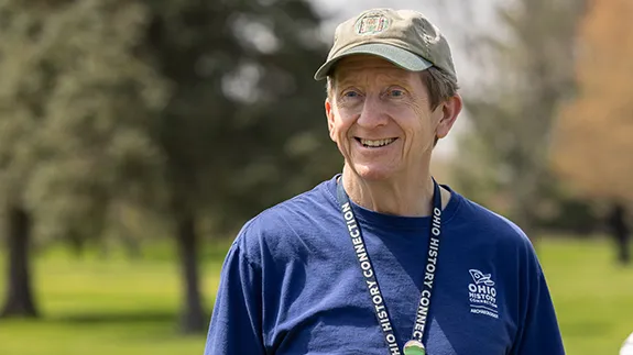 Bradley Lepper smiles as he speaks with visitors to the Great Circle Earthworks in Newark