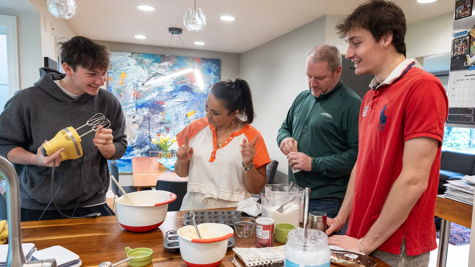 Michelle Brandt's family--her husband and two sons--assemble ingredients to make baked goods in their home. 