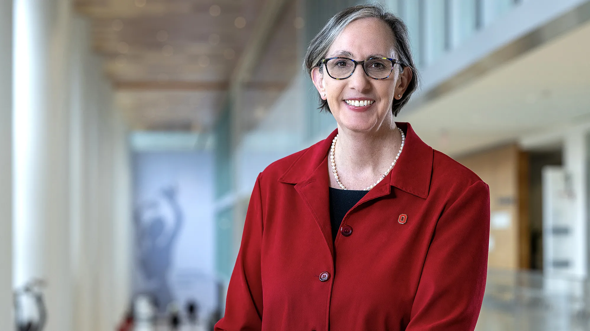 Dr. W. Kimryn Rathmell, the new leader of Ohio State's James Cancer Hospital, poses for this portrait. She is a white woman with hair cut just below chin-length, glasses and a friendly smile.