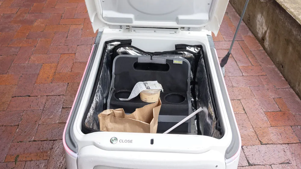 an open robot shows a deep well for food.