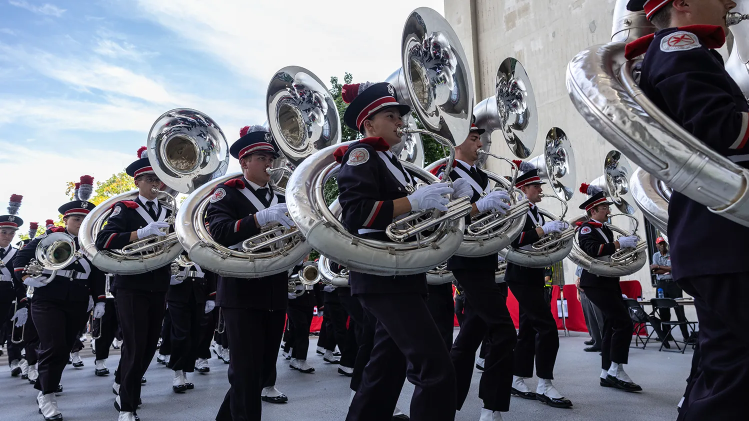 The Ohio State Marching Band carries their instruments while marching into Ohio Stadium.