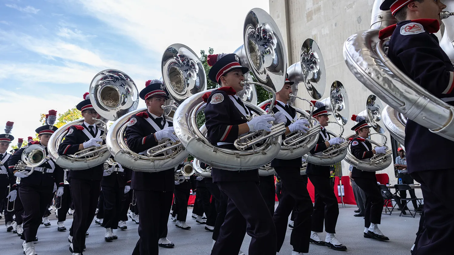 The Ohio State Marching Band carries their instruments while marching into Ohio Stadium.