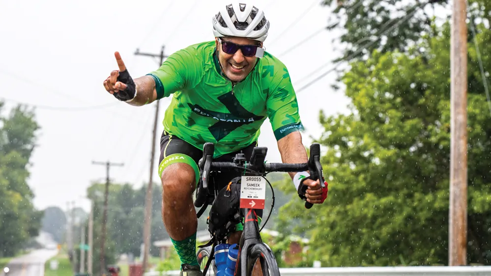 Roychowdhury rides in Pelotonia wearing a green no limits jersey