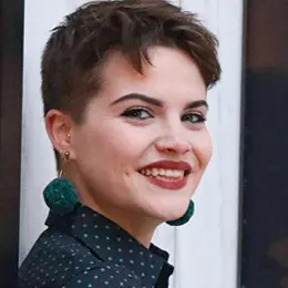 Headshot of Jessica Kavinsky, a white woman with short hair and red lipstick