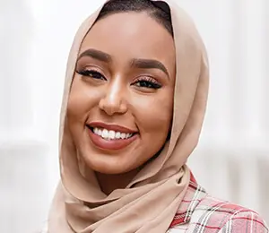 Headshot of Roaya Higazi, a woman of color wearing a hijab