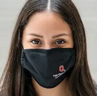 Woman with long dark hair wearing a black cloth facemask
