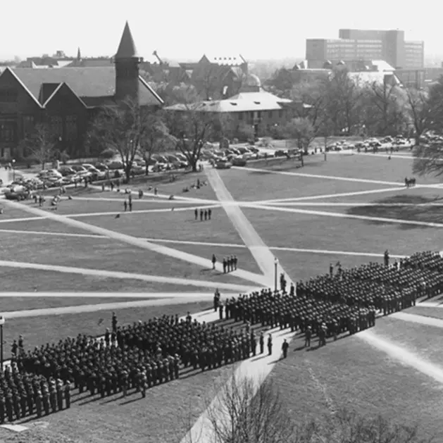 Black and white archival photo of ROTC soldiers standing in military formation on the Oval.