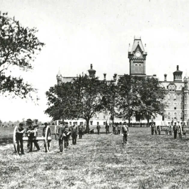 Black and white archival photo of military drills occurring on the Oval