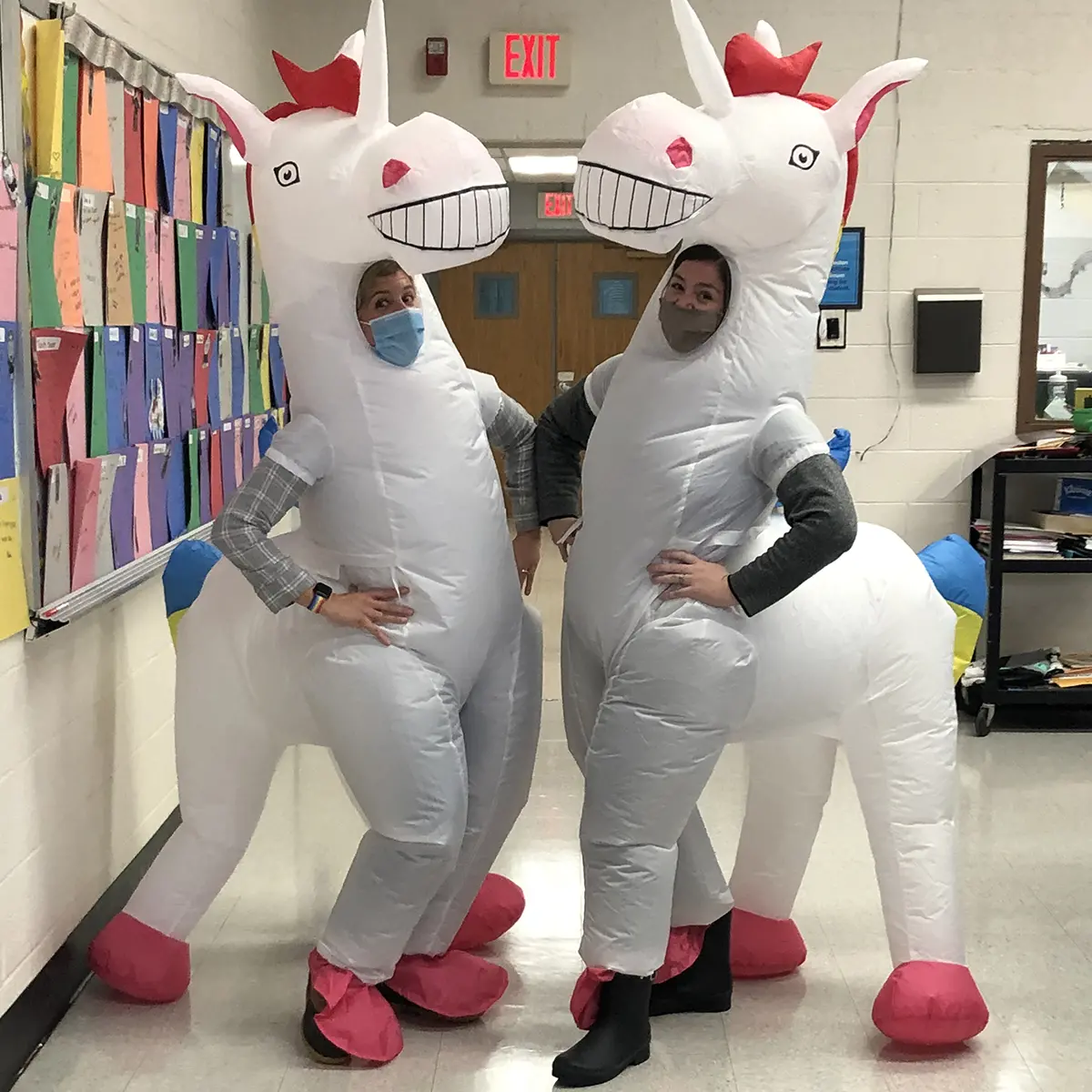Two teachers wear inflatable unicorn costumes