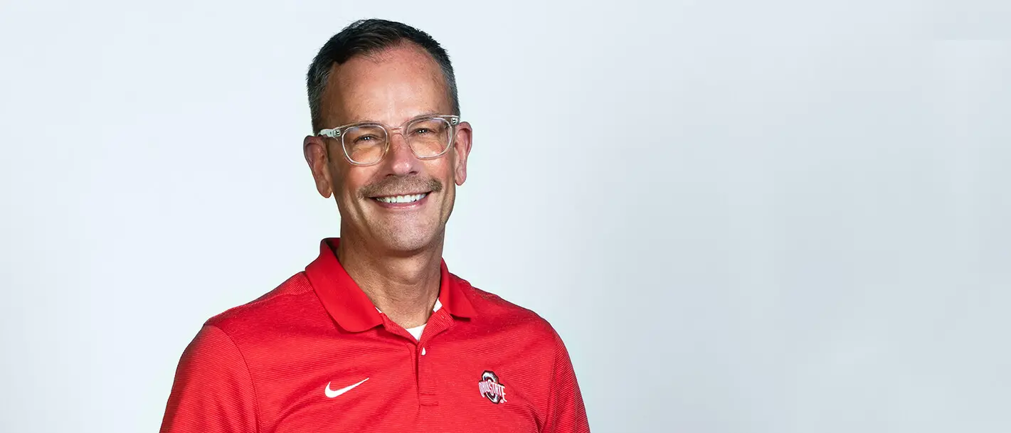 matt hall wearing a red ohio state polo smiling at camera