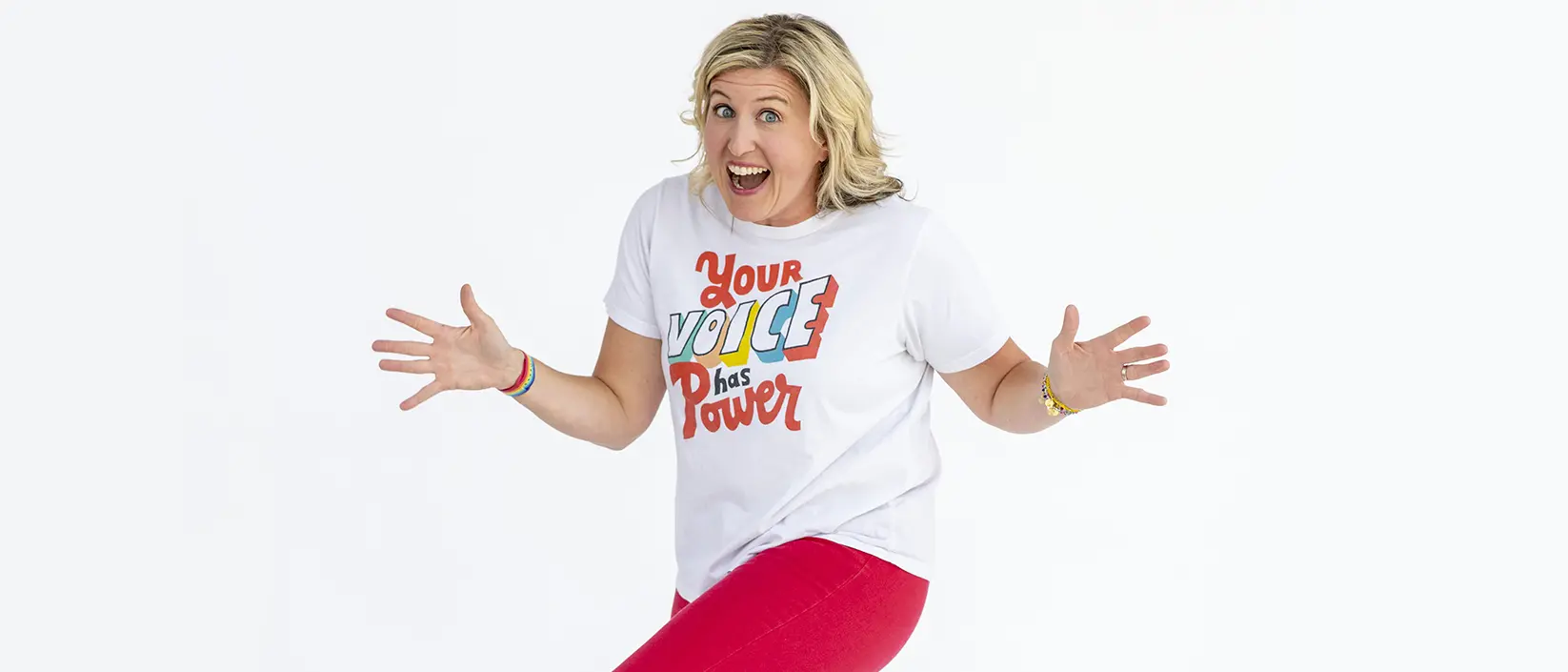 Katie Silcott dances in t-shirt that reads "Your voice has power."