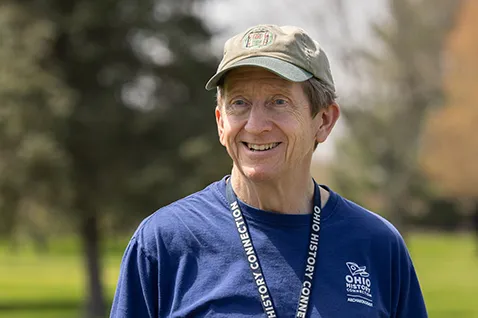 Bradley Lepper smiles as he speaks with visitors to the Great Circle Earthworks in Newark