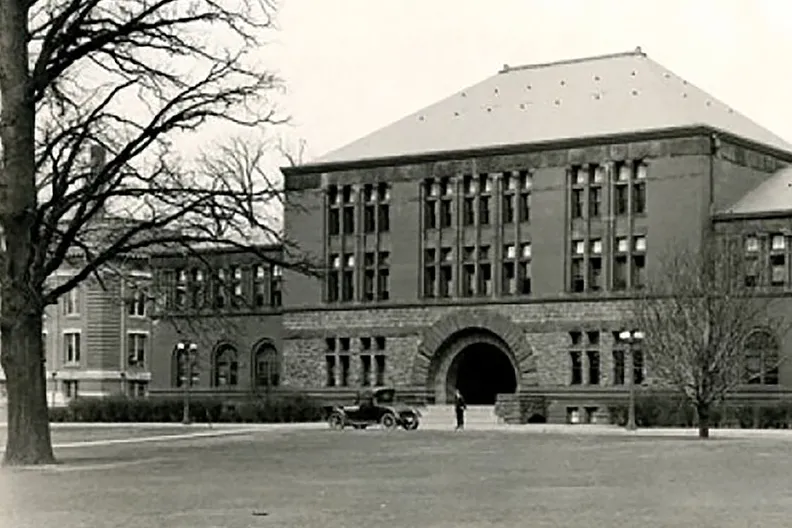 A black and white photo shows a bare Hayes Hall, a three-story academic building that gives off stately airs.