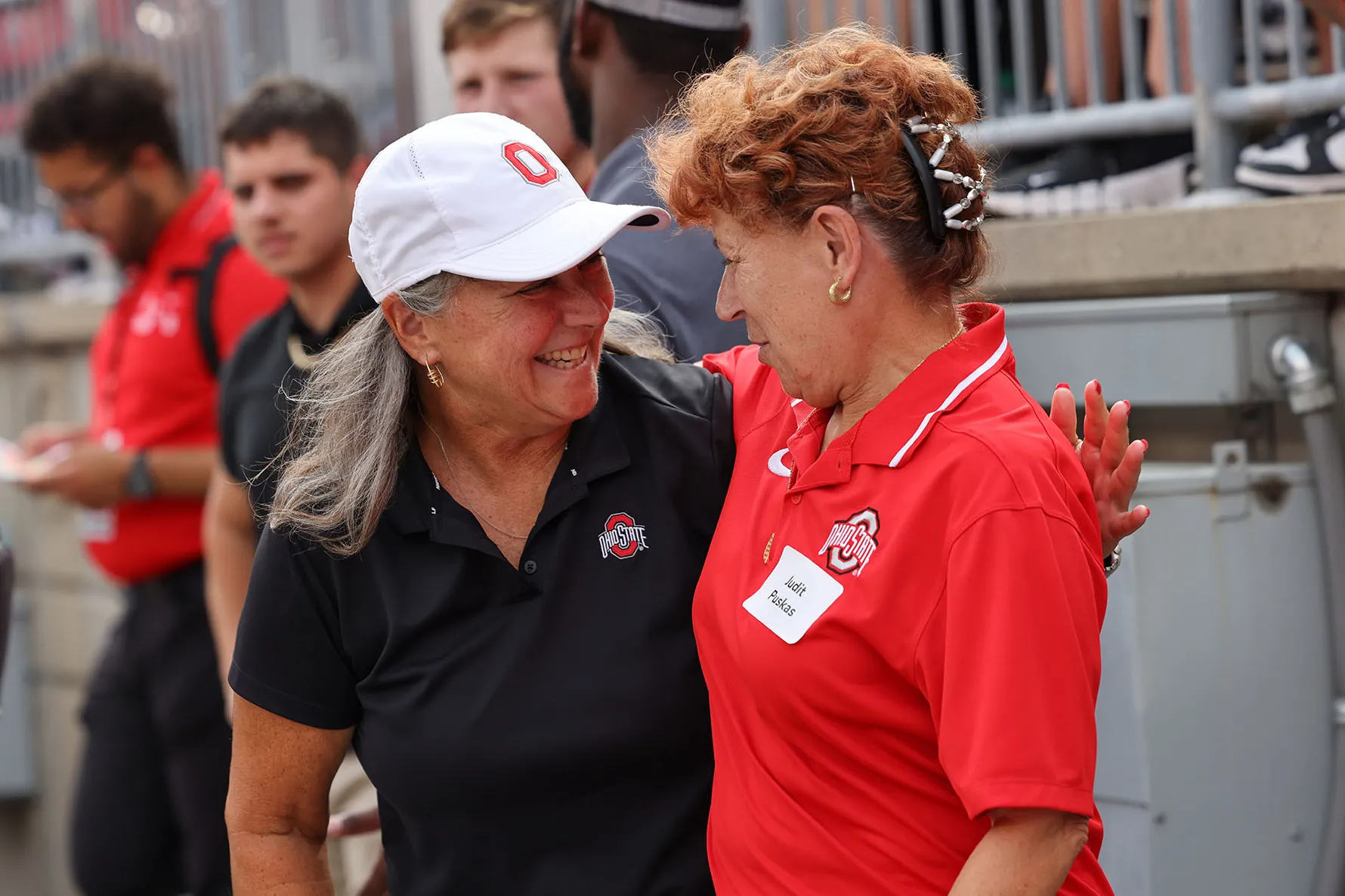 Molly grins as she wraps an arm around Distinguished Professor Judit Puskas.