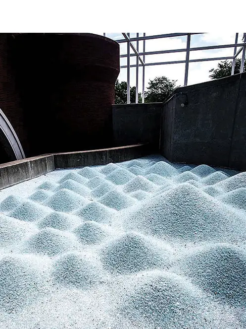 An art installation of numerous mounds of varying sizes of shattered automobile glass.
