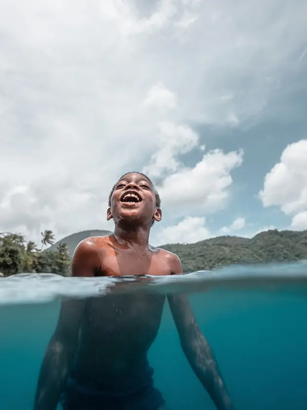 young boy enjoying playing in the water in Saint Lucia