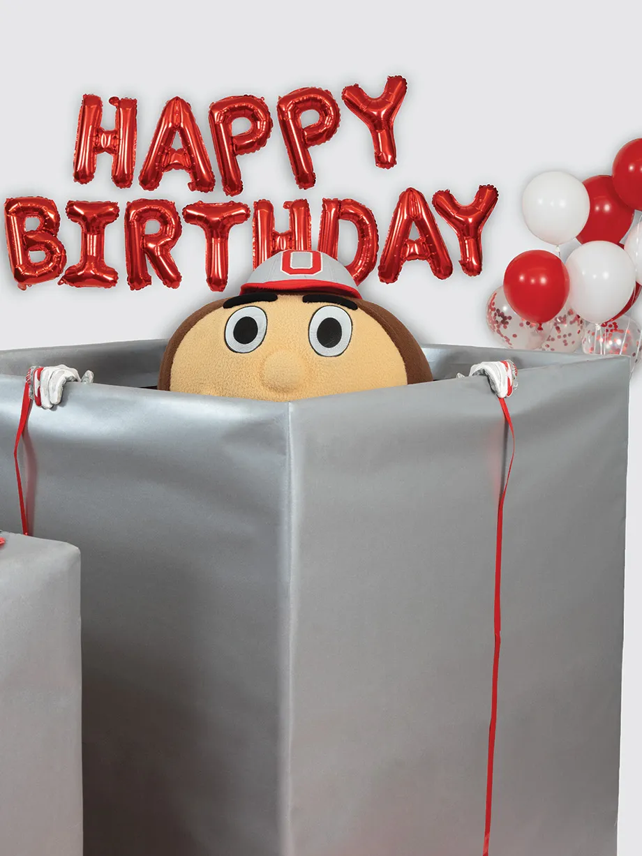Brutus peeks out of a gigantic gift wrapped box