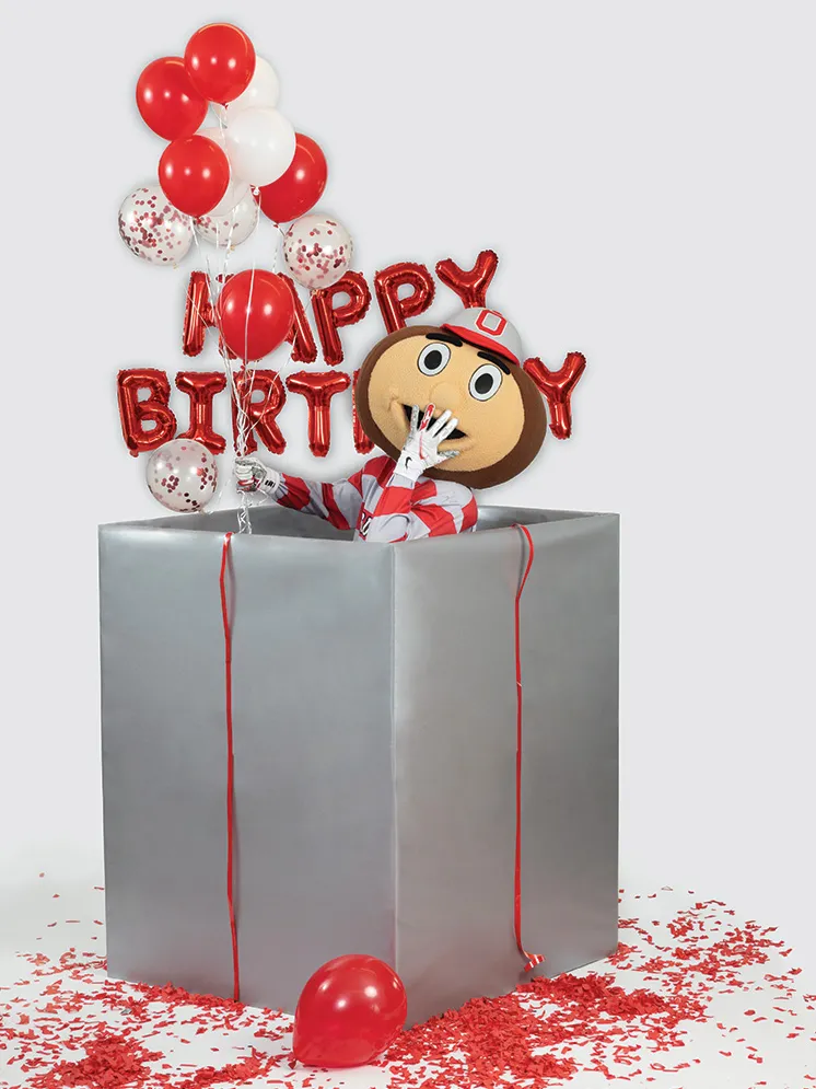 Brutus Buckeye covers his mouth with a hand as he giggles