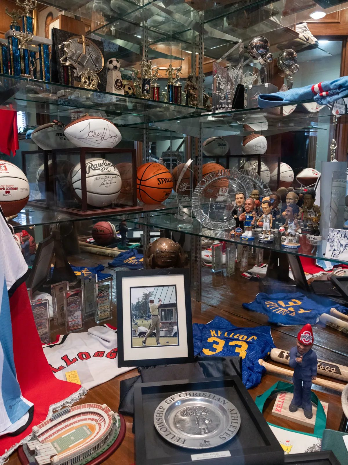 Shelving at his home holds a deep collection of signed balls, bobblehead dolls, trophies and framed photos and certificates, as well as jerseys.