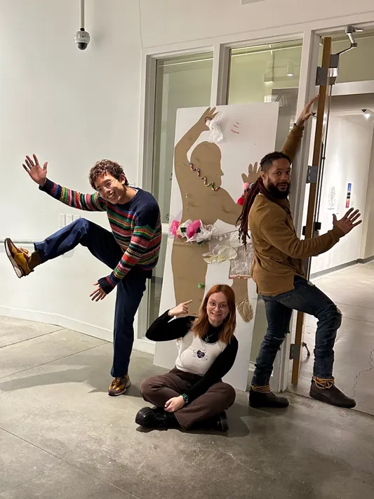 Banner goofs around with others inside Urban Arts Space