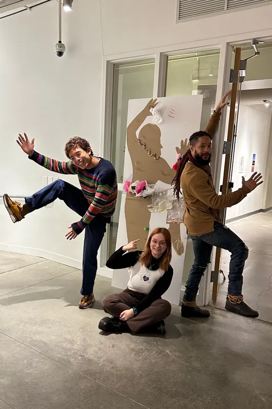 Banner goofs around with others inside Urban Arts Space