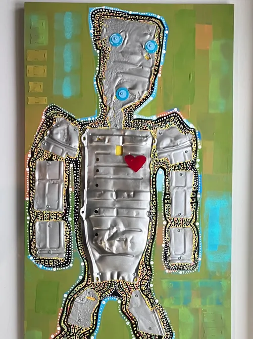 a mixed media work shows a robot with a heart and button eyes