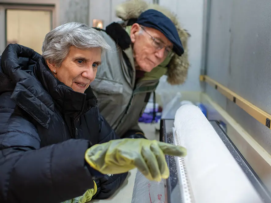 Lonnie Thompson and Ellen Mosley-Thompson examine an ice core.