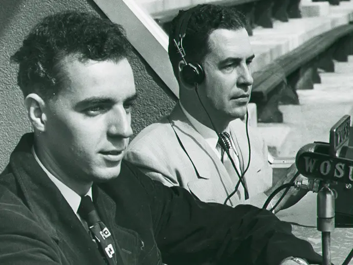 two men doing a radio report of a sporting event