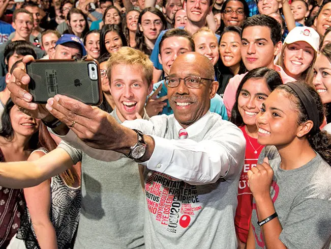 Michael V. Drake takes a selfie with students