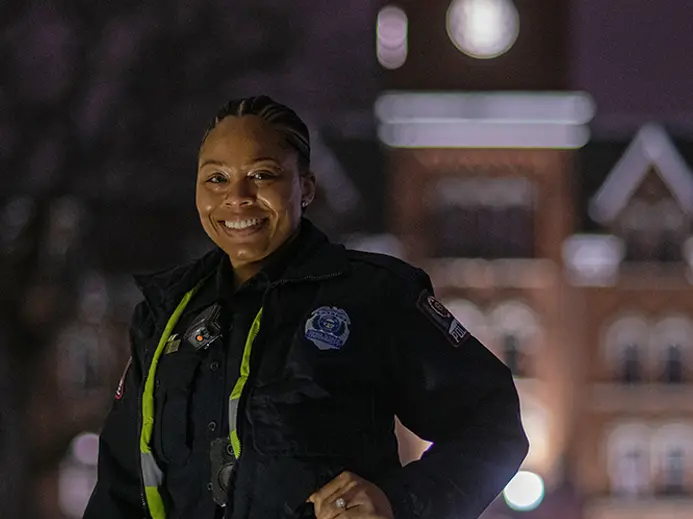 Officer Ari Ross portrait in uniform at night