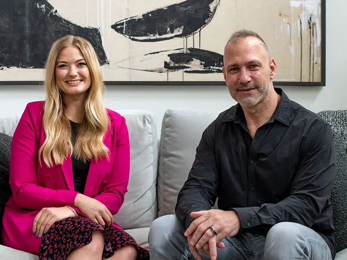 Maddie and Chris Spielman sitting on a couch