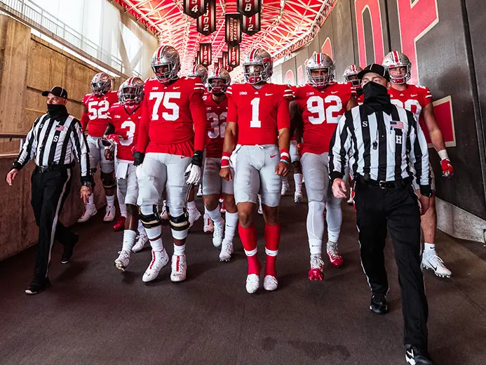 ohio state football players walk through the hallway of ohio stadium leading the way is number one